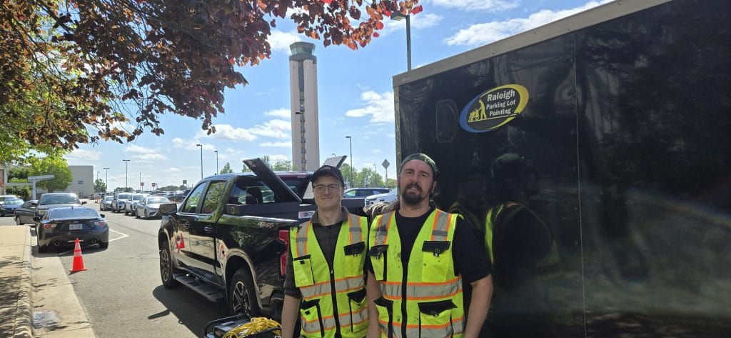 David and Jeremy painting parking lots at RDU international airport